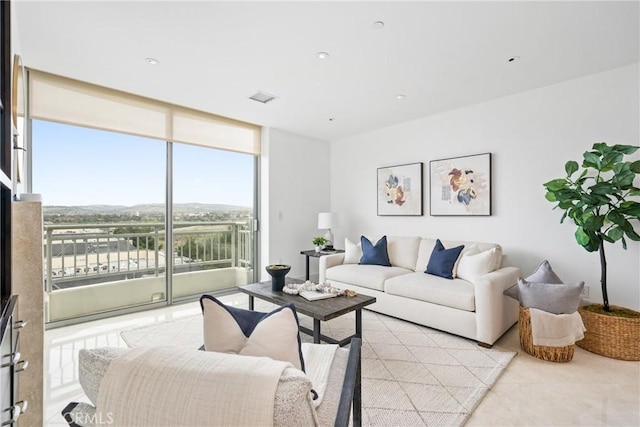 living room featuring light tile patterned floors, expansive windows, visible vents, and recessed lighting