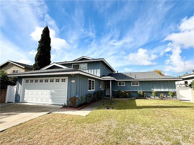 view of front of house featuring a garage, driveway, board and batten siding, and a front yard