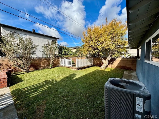 view of yard featuring a fenced backyard and central AC unit