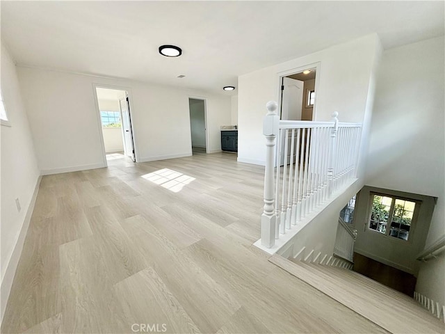 spare room with light wood finished floors and baseboards