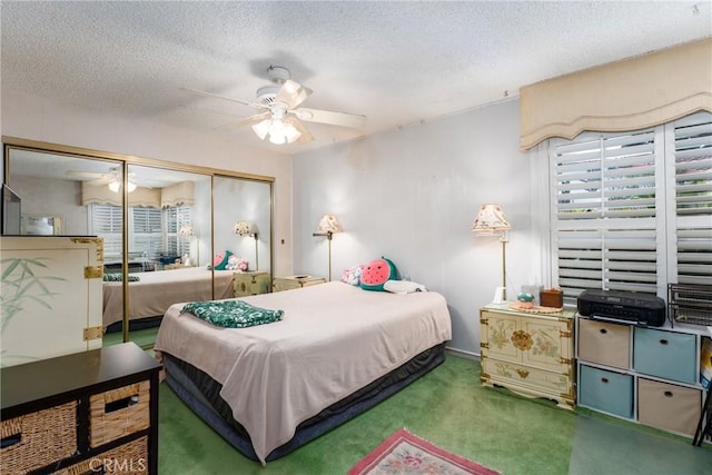 bedroom featuring carpet floors, a closet, a textured ceiling, and a ceiling fan