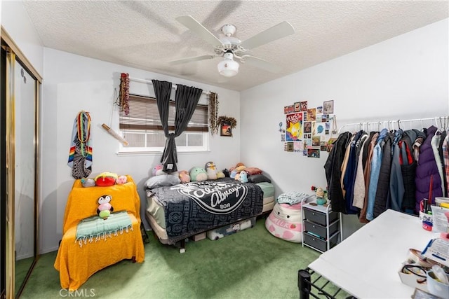 carpeted bedroom featuring a closet, ceiling fan, and a textured ceiling