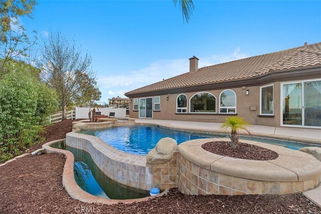 outdoor pool featuring fence and a patio area