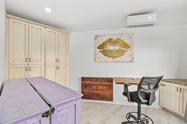 office area with recessed lighting, light wood finished floors, built in study area, and a wall mounted AC