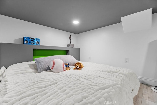 bedroom featuring recessed lighting and wood finished floors