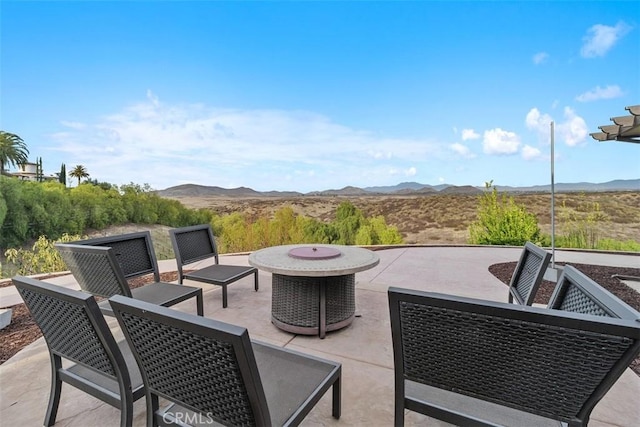 view of patio with an outdoor living space and a mountain view