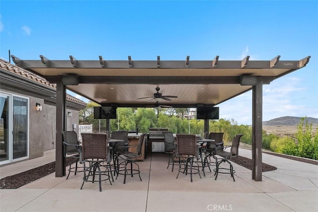 view of patio / terrace featuring outdoor dining space, a ceiling fan, and grilling area