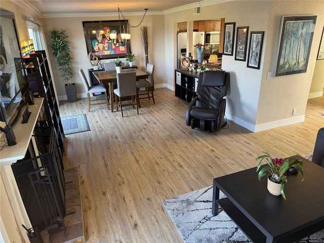 30266 Via Reata, Laguna Niguel, CA 92677 - living room with ornamental molding, light wood-style floors, baseboards, and a chandelier
