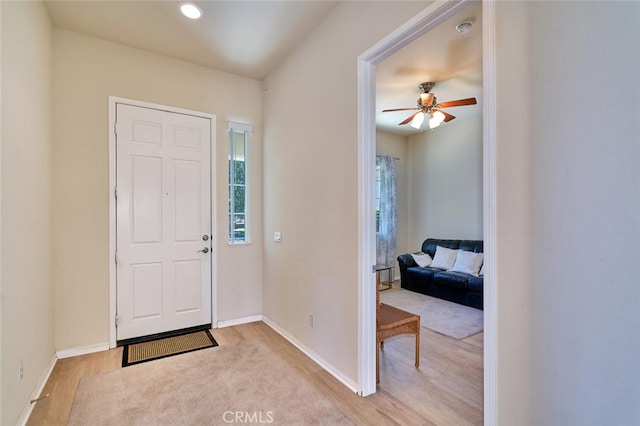 entryway featuring a ceiling fan, recessed lighting, light wood finished floors, and baseboards