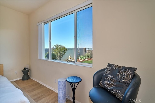 bedroom featuring baseboards and wood finished floors