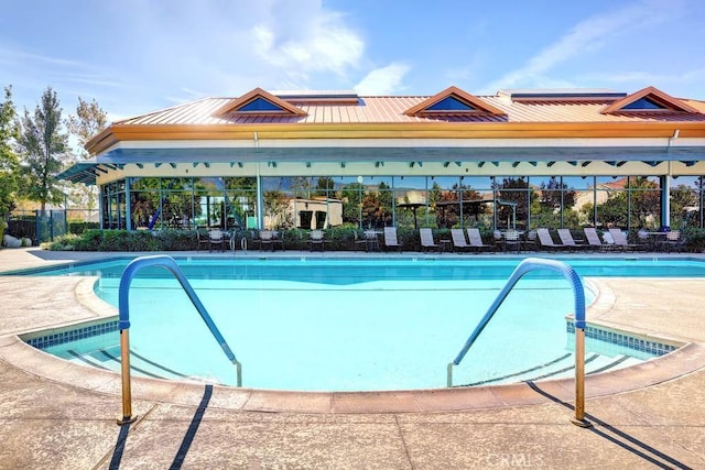 pool featuring fence and a patio