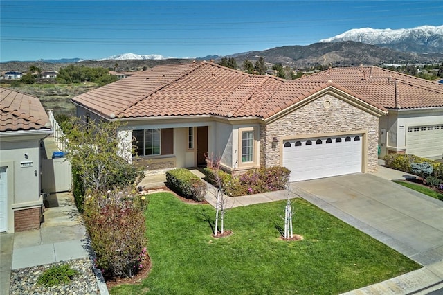 view of front of house with driveway, a garage, a tile roof, a mountain view, and a front yard