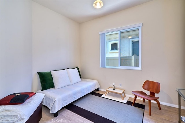 sitting room featuring baseboards and wood finished floors