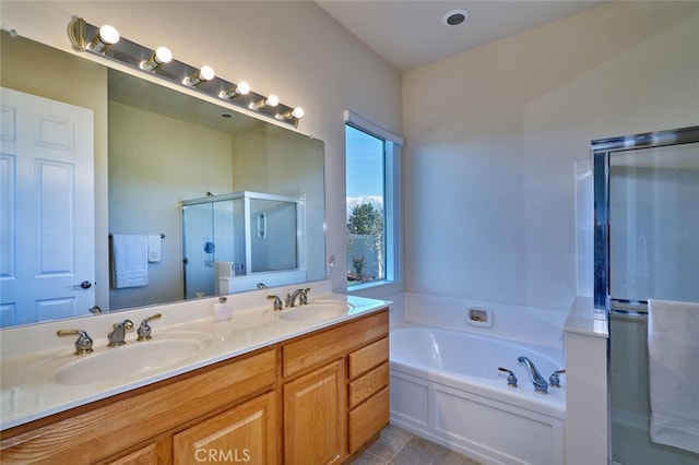 bathroom with a stall shower, double vanity, a sink, and a bath