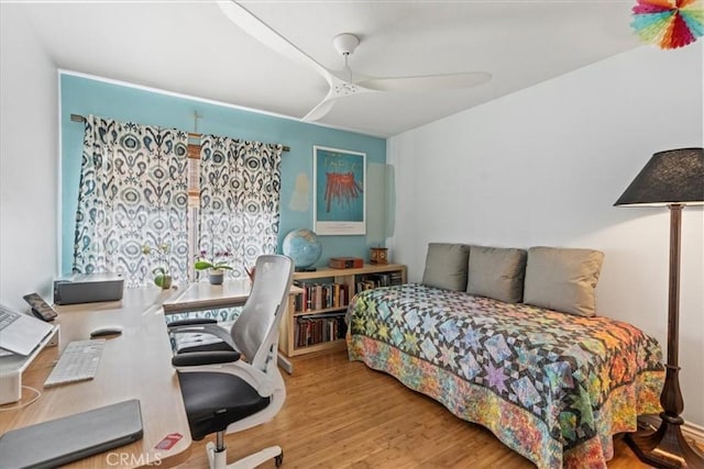 bedroom featuring wood finished floors and a ceiling fan