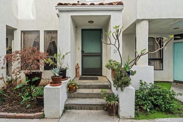 property entrance with a tile roof