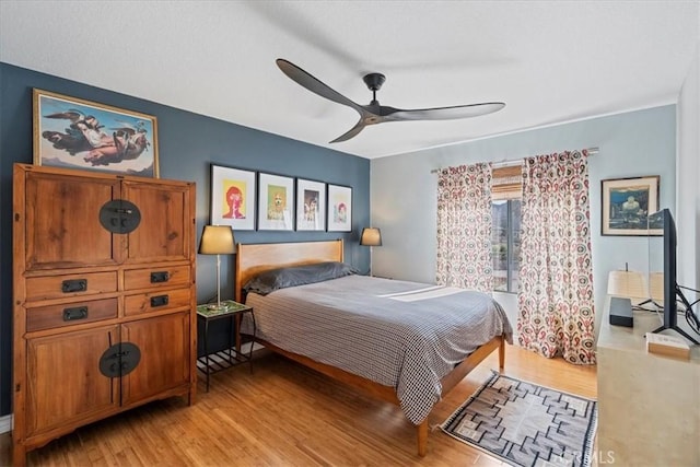 bedroom with light wood-style flooring and ceiling fan