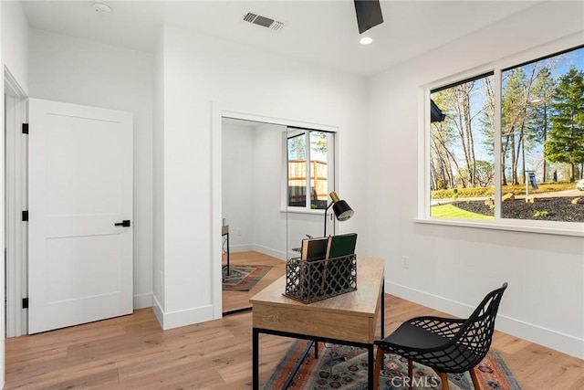 office space featuring light wood-type flooring, visible vents, baseboards, and recessed lighting