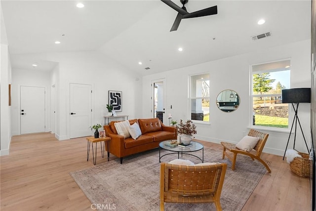 living room with lofted ceiling, light wood finished floors, visible vents, and a ceiling fan