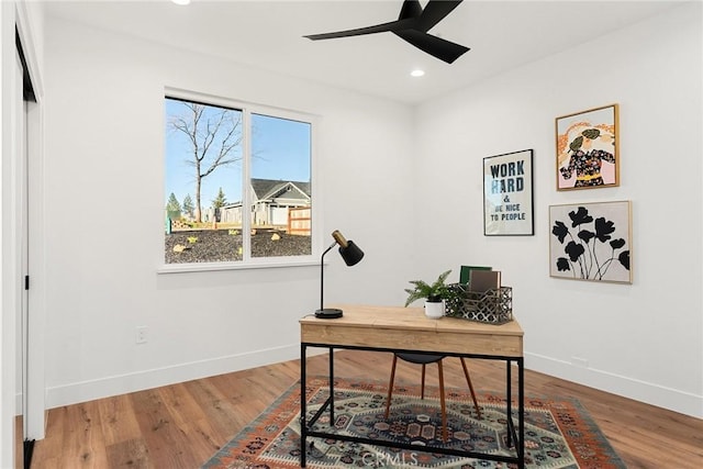 office featuring ceiling fan, wood finished floors, and baseboards