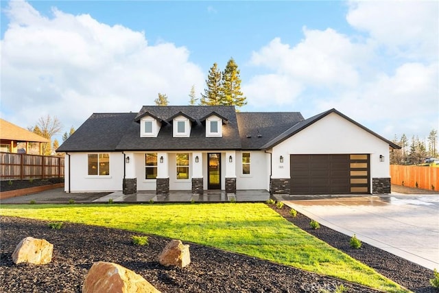 view of front of house featuring driveway, an attached garage, fence, and stucco siding