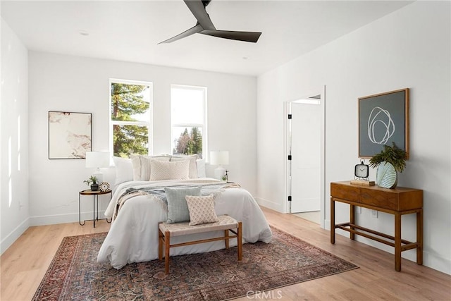 bedroom featuring ceiling fan, wood finished floors, and baseboards