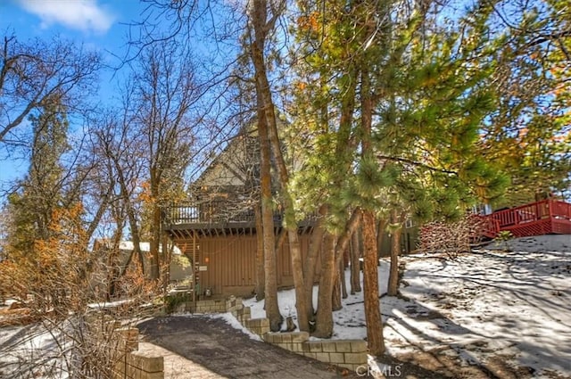 view of side of home with a wooden deck