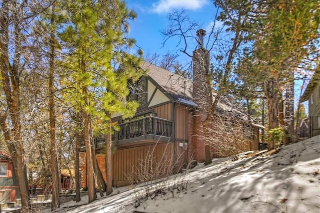 view of property exterior with board and batten siding and a chimney