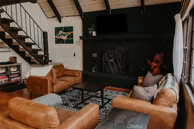 living area with vaulted ceiling with beams, wood ceiling, stairway, and wood finished floors