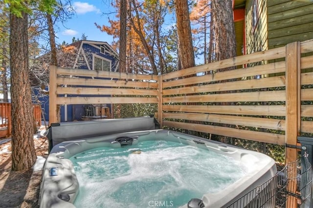 view of pool with a hot tub