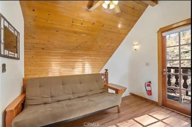 living area featuring lofted ceiling, wooden ceiling, ceiling fan, and wood finished floors