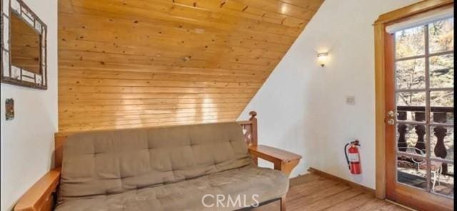 sitting room featuring wooden ceiling, vaulted ceiling, and wood finished floors