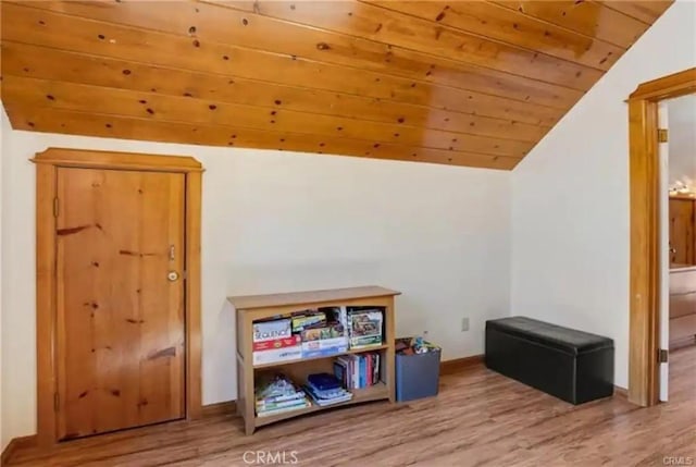 playroom featuring vaulted ceiling, wooden ceiling, wood finished floors, and baseboards