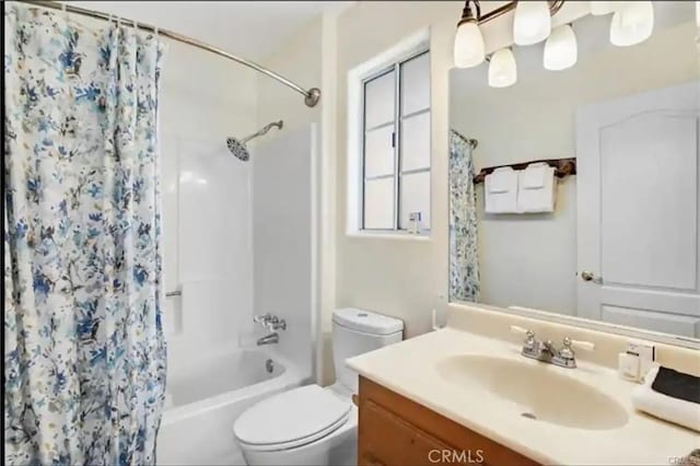 bathroom with toilet, shower / tub combo with curtain, and vanity