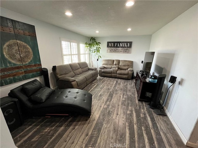 living area with recessed lighting, a textured ceiling, baseboards, and wood finished floors