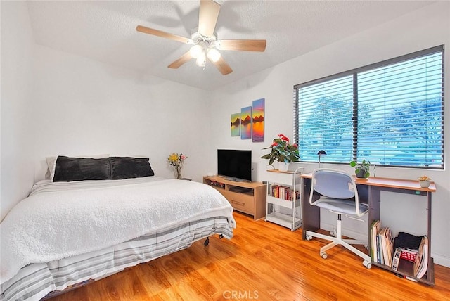 bedroom with ceiling fan and wood finished floors