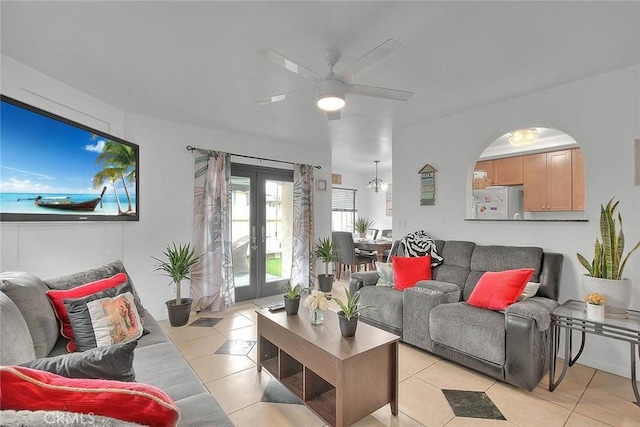 living room with light tile patterned floors, ceiling fan, and french doors