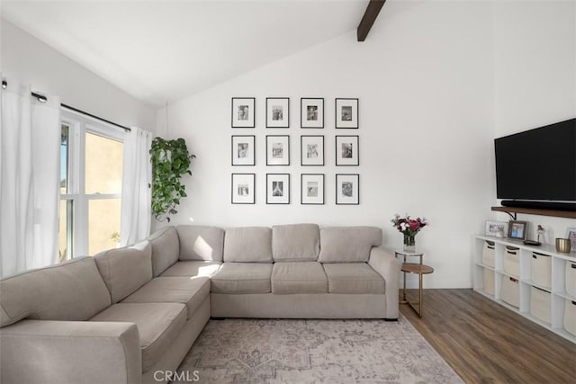 living room featuring vaulted ceiling with beams and wood finished floors