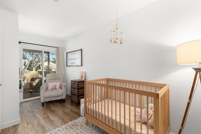 bedroom with baseboards and wood finished floors