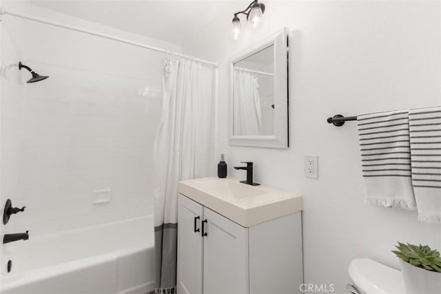 bathroom with vanity, toilet, and shower / bath combo