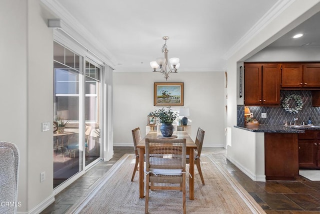 dining space with recessed lighting, stone tile floors, a notable chandelier, baseboards, and crown molding