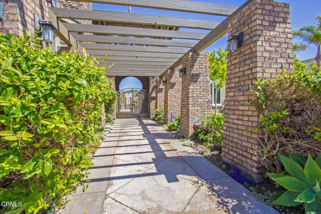 view of patio featuring a gate and a pergola