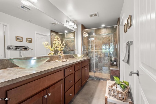 bathroom featuring a sink, a shower stall, and double vanity