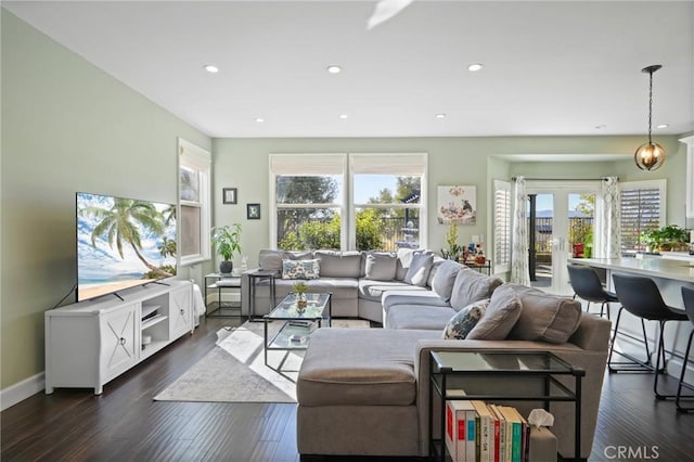 living room featuring dark wood finished floors, recessed lighting, french doors, and baseboards