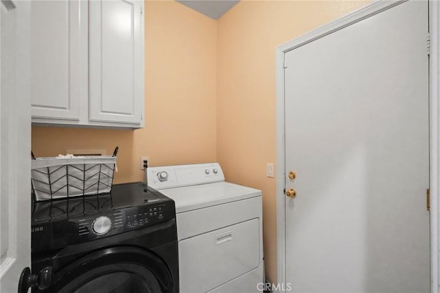 laundry area featuring washer and dryer and cabinet space