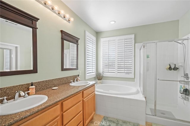 bathroom featuring a sink, a garden tub, a healthy amount of sunlight, and a shower stall