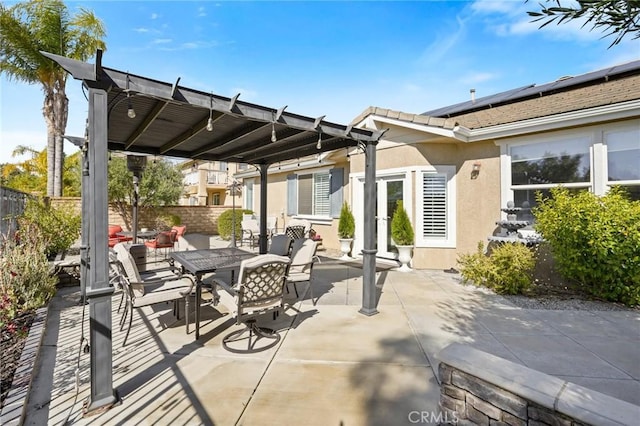 view of patio with outdoor dining area, fence, a pergola, and french doors