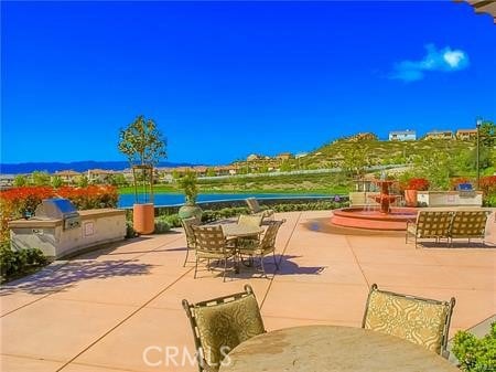 view of patio featuring outdoor dining area and an outdoor kitchen