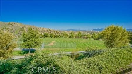 view of home's community with a rural view and a lawn