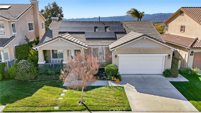 view of front facade with concrete driveway, a tile roof, and a front lawn